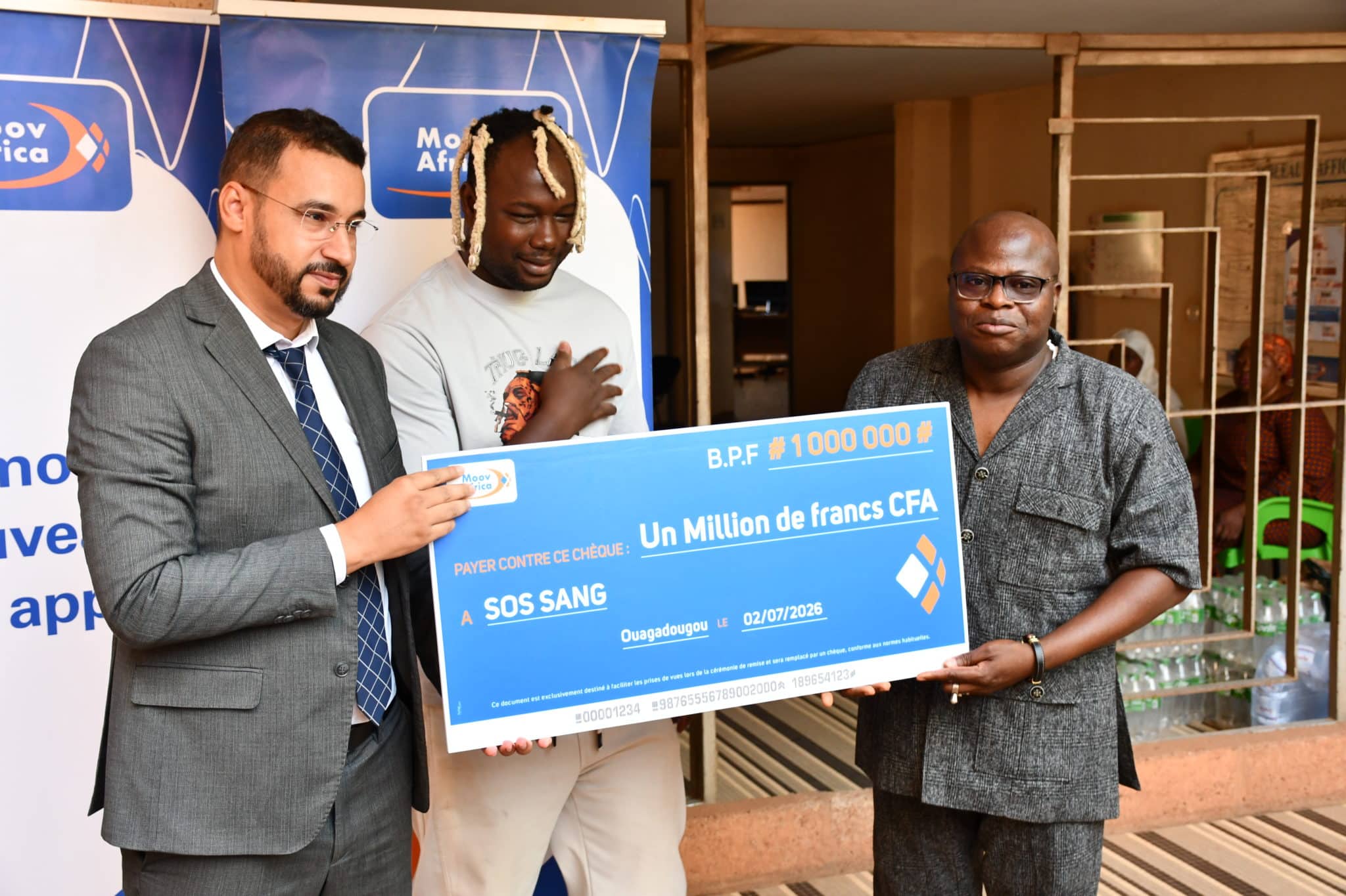 Le Directeur Général par intérim de Moov Africa Burkina Faso, Mohamed Saïd Oulad Jelloul, remettant officiellement le chèque d'un million de francs CFA à Jean Bosco Zoundi, président de l’association SOS Sang, pour soutenir les collectes mobiles